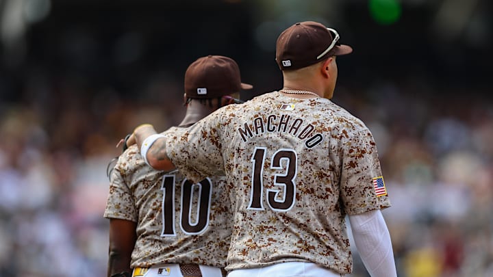 Sep 8, 2024; San Diego, California, USA; San Diego Padres third baseman Manny Machado (13) puts his arm around left fielder Jurickson Profar (10) before the sixth inning against the San Francisco Giants at Petco Park. Mandatory Credit: Chadd Cady-Imagn Images Sep 8, 2024; San Diego, California, USA; San Diego Padres third baseman Manny Machado (13) puts his arm around left fielder Jurickson Profar (10) before the sixth inning against the San Francisco Giants at Petco Park. Mandatory Credit: Chadd Cady-Imagn Images
