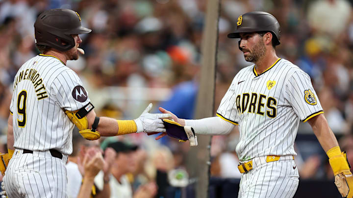 Sep 7, 2024; San Diego, California, USA; San Diego Padres third baseman Tyler Wade (14) celebrates with first baseman Jake Cronenworth (9) after scoring against the San Francisco Giants in the fifth inning at Petco Park. Mandatory Credit: Chadd Cady-Imagn Images