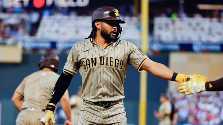 Aug 30, 2025; Minneapolis, Minnesota, USA; San Diego Padres right fielder Fernando Tatis Jr. (23) celebrates his run against the Minnesota Twins in the seventh inning at Target Field. Mandatory Credit: Bruce Kluckhohn-Imagn Images