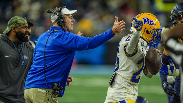Pittsburgh Panthers head coach Pat Narduzzi hits Pittsburgh Panthers running back Juelz Goff (26) on the helmet after getting a first down, during the first half of the 2024 GameAbove Sports Bowl at Ford Field in Detroit, Thursday, Dec. 26, 2024.