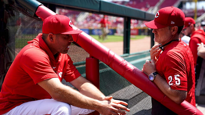 Former Cincinnati Reds first baseman Joey Votto (19) talks with Cincinnati Reds manager David Bell (25), right, in the dugout in the sixth inning during a baseball game between the St. Louis Cardinals and the Cincinnati Reds, Thursday, May 25, 2023, at Great American Ball Park in Cincinnati.