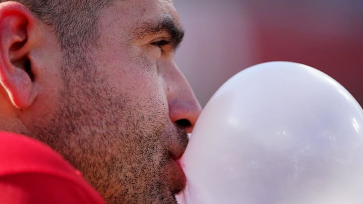 Cincinnati Reds designated hitter Joey Votto (19) blows a bubble at the top of the dugout steps during the ninth inning of a baseball game against the Baltimore Orioles, Sunday, July 31, 2022, Great American Ball Park in Cincinnati.