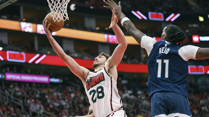 Dec 27, 2024; Houston, Texas, USA; Houston Rockets center Alperen Sengun (28) shoots the ball as Minnesota Timberwolves center Naz Reid (11) defends during the third quarter at Toyota Center. Mandatory Credit: Troy Taormina-Imagn Images