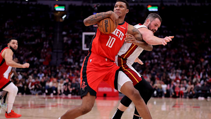 Dec 29, 2024; Houston, Texas, USA; Houston Rockets forward Jabari Smith Jr (10) grabs a loose ball against Miami Heat forward Kevin Love (42) during the third quarter at Toyota Center. Mandatory Credit: Erik Williams-Imagn Images
