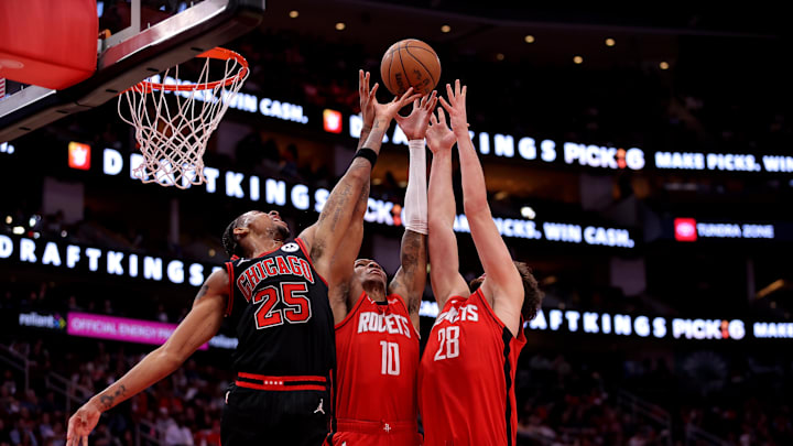 Mar 15, 2025; Houston, Texas, USA; Chicago Bulls forward Dalen Terry (25) battles Houston Rockets forward Jabari Smith Jr (10) and Houston Rockets center Alperen Sengun (28) for a rebound during the second quarter at Toyota Center. Mandatory Credit: Erik Williams-Imagn Images