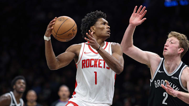 Jan 1, 2026; Brooklyn, New York, USA; Houston Rockets guard Amen Thompson (1) goes to the basket against Brooklyn Nets forward Danny Wolf (2) during the second half at Barclays Center. Mandatory Credit: Vincent Carchietta-Imagn Images