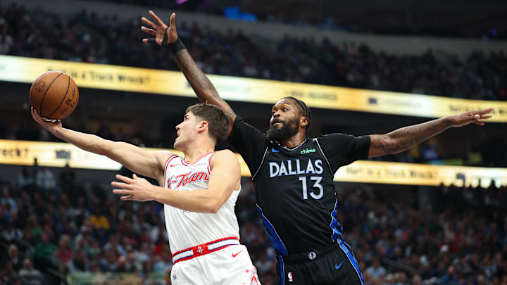 Jan 3, 2026; Dallas, Texas, USA;  Houston Rockets guard Reed Sheppard (15) drives to the basket past Dallas Mavericks forward Naji Marshall (13) during the first quarter at American Airlines Center. Mandatory Credit: Kevin Jairaj-Imagn Images