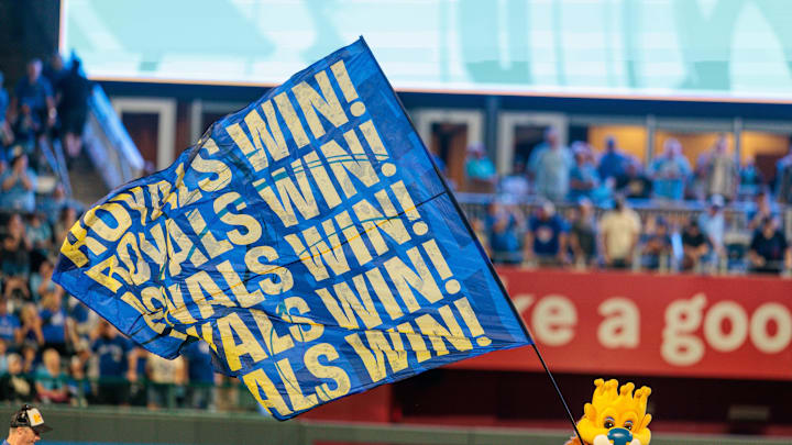 Sep 20, 2025; Kansas City, Missouri, USA; Kansas City Royals mascot Slugger runs with the Royals Win flag after the game against the Toronto Blue Jays at Kauffman Stadium.