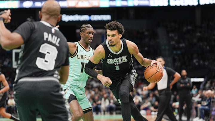 San Antonio Spurs center Victor Wembanyama (1) goes to the basket against Charlotte Hornets forward Moussa Diabate (14) during the second half at Spectrum Center. Mandatory Credit: Jim Dedmon-Imagn Images