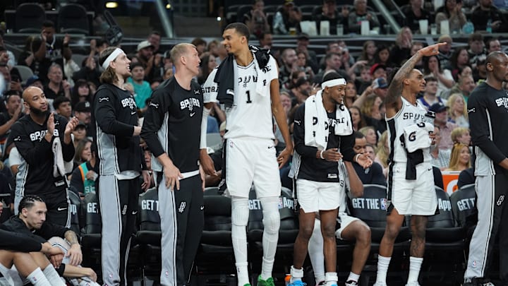 Mar 30, 2026; San Antonio, Texas, USA;  San Antonio Spurs forward Kelly Olynyk (8), center Mason Plumlee (45), forward Victor Wembanyama (1), guard De'aaron Fox (4), and guard Devin Vassell (24) celebrate on the bench in the second half against the Chicago Bulls at Frost Bank Center. Mandatory Credit: Daniel Dunn-Imagn Images