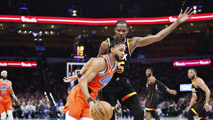 Oklahoma City Thunder guard Isaiah Joe moves past Phoenix Suns forward Kevin Durant.