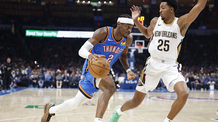 Nov 13, 2024; Oklahoma City, Oklahoma, USA; Oklahoma City Thunder guard Shai Gilgeous-Alexander (2) drives around New Orleans Pelicans guard Trey Murphy III (25) on the way to the basket during the second quarter at Paycom Center. Mandatory Credit: Alonzo Adams-Imagn Images