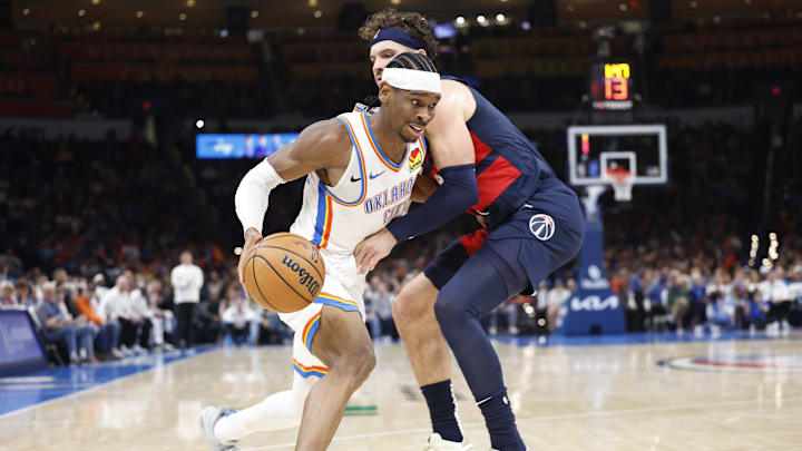 Dec 23, 2024; Oklahoma City, Oklahoma, USA; Oklahoma City Thunder guard Shai Gilgeous-Alexander (2) moves the ball around Washington Wizards forward Corey Kispert (24) during the second half at Paycom Center. Mandatory Credit: Alonzo Adams-Imagn Images