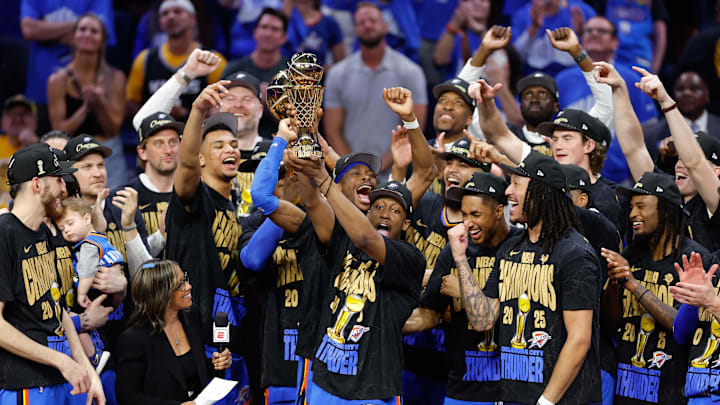 Jun 22, 2025; Oklahoma City, Oklahoma, USA; Oklahoma City Thunder forward Jalen Williams (8) holds up the Bill Russell NBA Finals MVP trophy after winner Oklahoma City Thunder guard Shai Gilgeous-Alexander hands it to him at the end of game seven of the 2025 NBA Finals against the Indiana Pacers at Paycom Center. Mandatory Credit: Alonzo Adams-Imagn Images