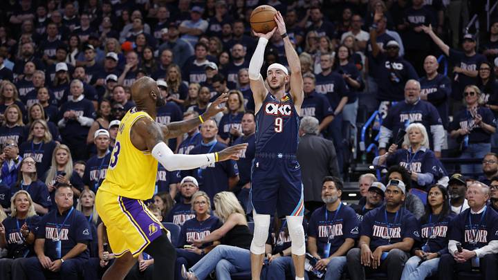 May 7, 2026; Oklahoma City, Oklahoma, USA; Oklahoma City Thunder guard Alex Caruso (9) shoots a three point basket as Los Angeles Lakers forward LeBron James (23) defends in the second half during game two of the second round of the 2026 NBA Playoffs at Paycom Center. Mandatory Credit: Alonzo Adams-Imagn Images
