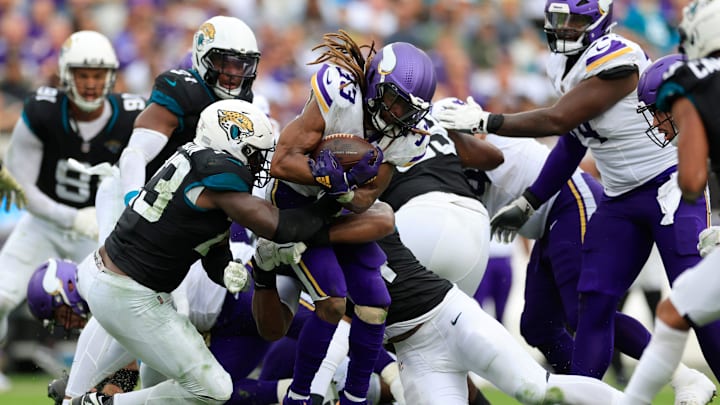 Minnesota Vikings running back Aaron Jones, center, is sandwiched between Jacksonville Jaguars linebacker Foyesade Oluokun, left, and defensive end Travon Walker during the third quarter on Sunday, Nov. 10, 2024, at Everbank Stadium in Jacksonville, Fla.