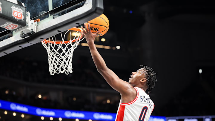 Mar 13, 2025; Kansas City, MO, USA; Arizona Wildcats guard Jaden Bradley (0) shoots the ball during the first half against the Kansas Jayhawks at T-Mobile Center. Mandatory Credit: William Purnell-Imagn Images