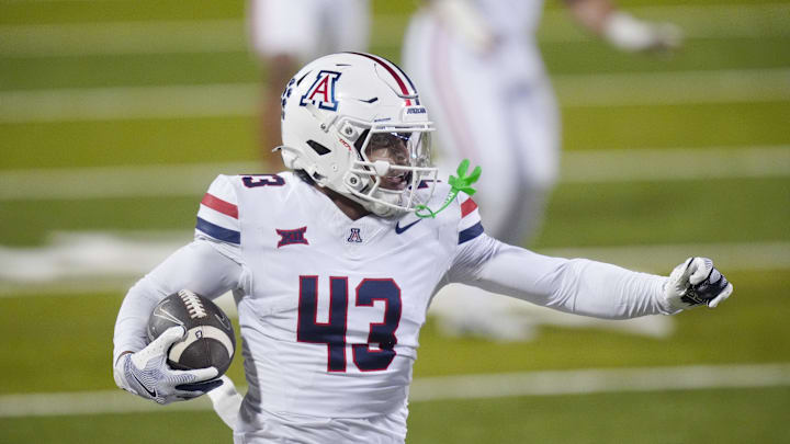 Nov 1, 2025; Boulder, Colorado, USA; Arizona Wildcats defensive back Dalton Johnson (43) returns the ball after an interception in the second quarter against the Colorado Buffaloes at Folsom Field. Mandatory Credit: Ron Chenoy-Imagn Images