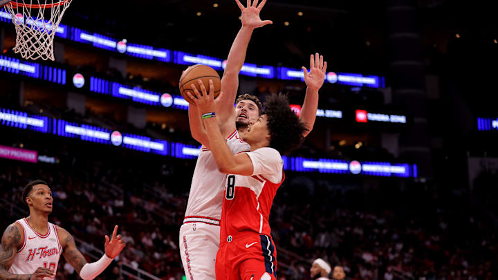 Nov 12, 2025; Houston, Texas, USA; Washington Wizards forward Kyshawn George (18) shoots inside against Houston Rockets center Alperen Sengun (28) during the third quarter at Toyota Center. Mandatory Credit: Erik Williams-Imagn Images