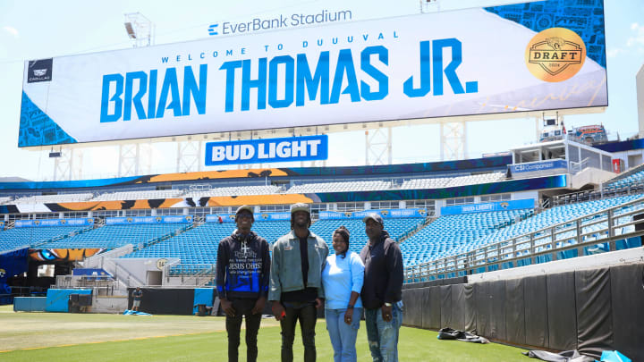 Jacksonville Jaguars wide receiver Brian Thomas Jr., center left, cousin, Leantre Thomas, left, mother, Sondra Thomas, center right, and father, Brian Thomas Sr., pose for a photo before a press conference Friday, April 26, 2024 at EverBank StadiumÕs Miller Electric Center in Jacksonville, Fla. Jacksonville Jaguars selected LSUÕs wide receiver Brian Thomas Jr. as the 23rd overall pick in last nightÕs NFL Draft. [Corey Perrine/Florida Times-Union]