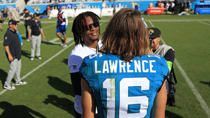 Jacksonville Jaguars quarterback Trevor Lawrence (16) greets Indianapolis Colts quarterback Anthony Richardson (5) after the game an NFL football matchup Sunday, Oct. 15, 2023 at EverBank Stadium in Jacksonville, Fla. The Jacksonville Jaguars defeated the Indianapolis Colts 37-20. Richardson did not play because of a shoulder injury. [Corey Perrine/Florida Times-Union]