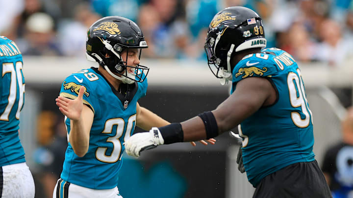 Jacksonville Jaguars place kicker Cam Little (39) high-fives defensive tackle Esezi Otomewo (90) after kicking the game-winning field goal during the fourth quarter of an NFL football matchup Sunday, Oct. 6, 2024 at EverBank Stadium in Jacksonville, Fla. The Jaguars edged the Colts on a field goal 37-34. [Corey Perrine/Florida Times-Union]