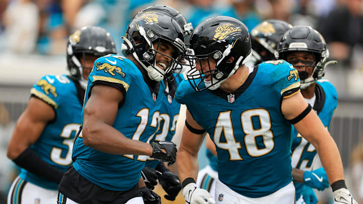 Jacksonville Jaguars wide receiver Devin Duvernay (12) is celebrated by linebacker Chad Muma (48) for his long rush during the third quarter of an NFL football matchup Sunday, Oct. 6, 2024 at EverBank Stadium in Jacksonville, Fla. The Jaguars edged the Colts on a field goal 37-34. [Corey Perrine/Florida Times-Union]