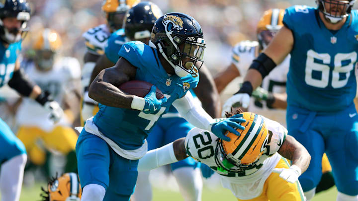 Jacksonville Jaguars running back Tank Bigsby (4) stiff arm Green Bay Packers safety Javon Bullard (20) during the second quarter of an NFL football matchup Sunday, Oct. 27, 2024 at EverBank Stadium in Jacksonville, Fla. [Corey Perrine/Florida Times-Union]
