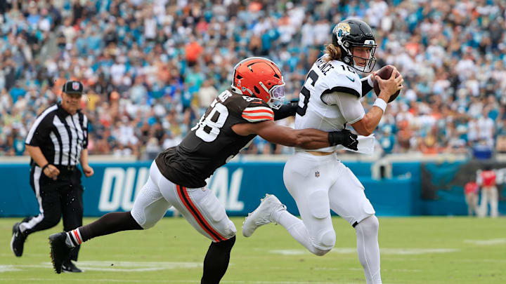 Jacksonville Jaguars quarterback Trevor Lawrence (16) is wrapped up by Cleveland Browns linebacker Jordan Hicks (58) during the second quarter of an NFL football matchup Sunday, Sept. 15, 2024 at EverBank Stadium in Jacksonville, Fla. The Browns defeated the Jaguars 18-13. [Corey Perrine/Florida Times-Union]
