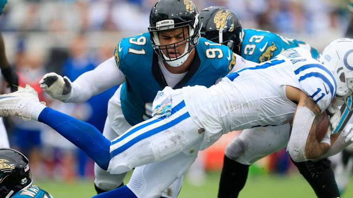 Jacksonville Jaguars defensive end Arik Armstead (91) helps on the tackle against Indianapolis Colts wide receiver Michael Pittman Jr. (11) during the third quarter of an NFL football matchup Sunday, Oct. 6, 2024 at EverBank Stadium in Jacksonville, Fla. The Jaguars edged the Colts on a field goal 37-34. [Corey Perrine/Florida Times-Union]