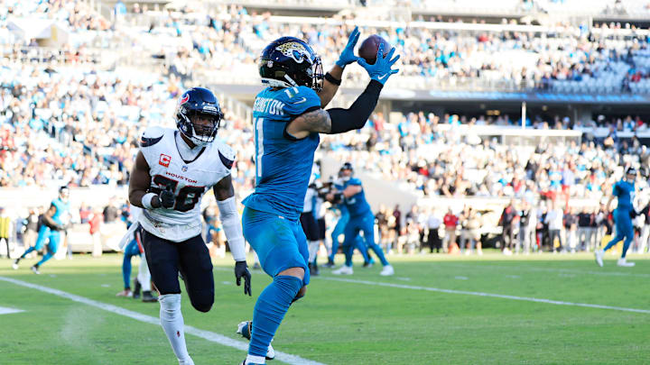 Jacksonville Jaguars wide receiver Parker Washington (11) hauls in a two-point conversion against Houston Texans safety Jimmie Ward (20) during the fourth quarter of an NFL football matchup Sunday, Dec. 1, 2024 at EverBank Stadium in Jacksonville, Fla. The Texans held off the Jaguars 23-20. [Corey Perrine/Florida Times-Union]