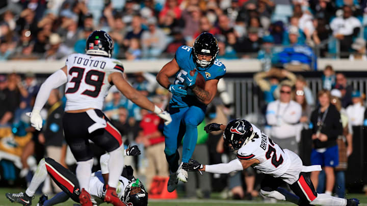 Houston Texans cornerback Kamari Lassiter (4) looks at a leaping Jacksonville Jaguars tight end Brenton Strange (85) as Houston Texans cornerback Myles Bryant (27) can’t make the stop and linebacker Henry To'oTo'o (39) looks on during the third quarter of an NFL football matchup Sunday, Dec. 1, 2024 at EverBank Stadium in Jacksonville, Fla. The Texans held off the Jaguars 23-20. [Corey Perrine/Florida Times-Union]
