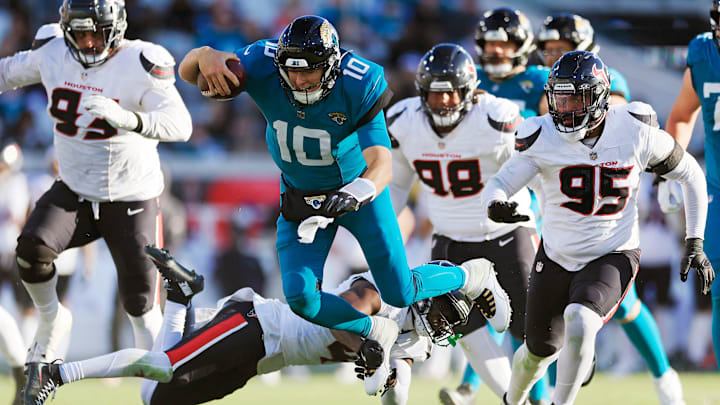 Jacksonville Jaguars quarterback Mac Jones (10) is tackled by Houston Texans cornerback Kamari Lassiter (4) during the fourth quarter of an NFL football matchup Sunday, Dec. 1, 2024 at EverBank Stadium in Jacksonville, Fla. The Texans held off the Jaguars 23-20. [Corey Perrine/Florida Times-Union]