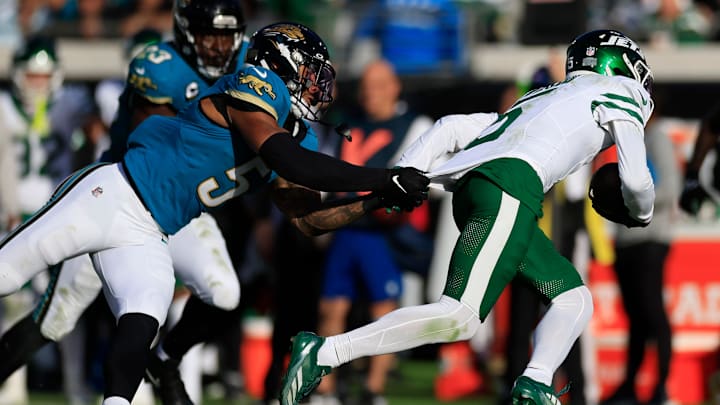 Jacksonville Jaguars safety Andre Cisco (5), left, tackles New York Jets wide receiver Garrett Wilson (5) during the fourth quarter Sunday, Dec. 15, 2024 at EverBank Stadium in Jacksonville, Fla. The Jets held off the Jaguars 32-25. [Corey Perrine/Florida Times-Union]