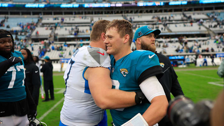 Tennessee Titans offensive tackle Chandler Brewer (67), left, hugs Jacksonville Jaguars quarterback Mac Jones (10) after the game Sunday, Dec. 29, 2024 at EverBank Stadium in Jacksonville, Fla. The Jaguars held off the Titans 20-13. [Corey Perrine/Florida Times-Union]