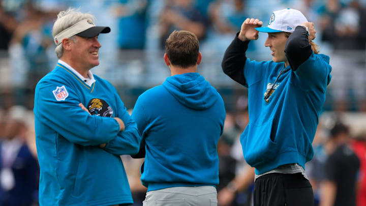 Jacksonville Jaguars head coach Doug Pederson, from left, offensive coordinator Press Taylor and quarterback Trevor Lawrence (16) talk mid-field before an NFL football matchup Sunday, Dec. 15, 2024 at EverBank Stadium in Jacksonville, Fla. [Corey Perrine/Florida Times-Union]