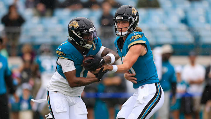 Jacksonville Jaguars quarterback Trevor Lawrence (16) hands off to running back Travis Etienne Jr. (1) before an NFL football matchup Sunday, Oct. 6, 2024 at EverBank Stadium in Jacksonville, Fla. [Corey Perrine/Florida Times-Union]
