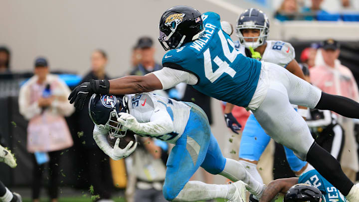 Jacksonville Jaguars defensive end Travon Walker (44) and cornerback Jarrian Jones (22) combine to tackle Tennessee Titans running back Julius Chestnut (36) during the fourth quarter Sunday, Dec. 29, 2024 at EverBank Stadium in Jacksonville, Fla. The Jaguars held off the Titans 20-13. [Corey Perrine/Florida Times-Union]