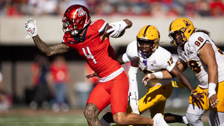 Nov 30, 2024; Tucson, Arizona, USA; Arizona Wildcats wide receiver Tetairoa McMillan (4) against the Arizona State Sun Devils in the first half during the Territorial Cup at Arizona Stadium. Mandatory Credit: Mark J. Rebilas-Imagn Images
