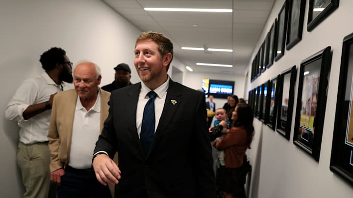 Liam Coen, center, walks with his father Tim Coen, left, as Edna Garcia, mother-in-law, right, holds son Callahan Coen, 7 months, after speaking and being introduced as the new Jacksonville Jaguars head cocah during a press conference Monday, Jan. 27, 2025 at the Miller Electric Center in Jacksonville, Fla. [Corey Perrine/Florida Times-Union]