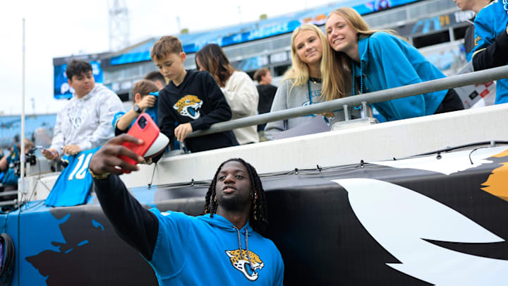 Jacksonville Jaguars wide receiver Brian Thomas Jr. (7) takes a selfie with fans before an NFL football matchup Sunday, Dec. 29, 2024 at EverBank Stadium in Jacksonville, Fla. [Corey Perrine/Florida Times-Union]