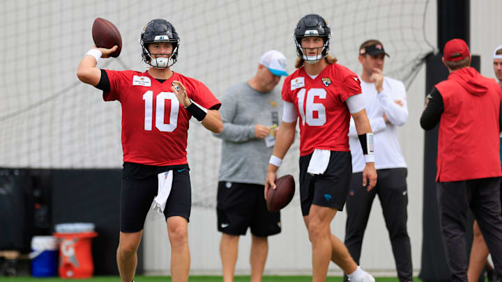 Jacksonville Jaguars quarterback Mac Jones (10) throws the ball as quarterback Trevor Lawrence (16) looks on during a combined NFL football training camp session between the Tampa Bay Buccaneers and Jacksonville Jaguars Thursday, Aug. 15, 2024 at EverBank Stadium’s Miller Electric Center in Jacksonville, Fla. [Corey Perrine/Florida Times-Union]