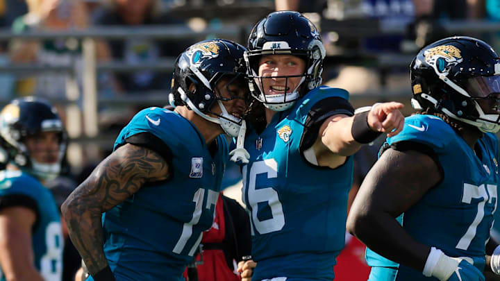 Jacksonville Jaguars quarterback Trevor Lawrence (16) celebrates with tight end Evan Engram (17) on his touchdown catch during the fourth quarter of an NFL football matchup Sunday, Oct. 27, 2024 at EverBank Stadium in Jacksonville, Fla. The Packers edged the Jaguars 30-27 on a last-second field goal. [Corey Perrine/Florida Times-Union]