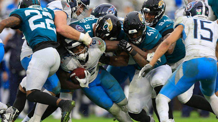 Tennessee Titans running back Tyjae Spears (2) rushes for yards against Jacksonville Jaguars defensive end Arik Armstead (91) and defensive end Josh Hines-Allen (41) during the second quarter of an NFL football matchup Sunday, Dec. 29, 2024 at EverBank Stadium in Jacksonville, Fla. [Corey Perrine/Florida Times-Union]
