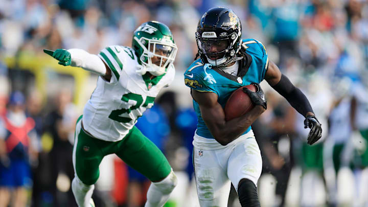 Jacksonville Jaguars wide receiver Brian Thomas Jr. (7) rushes for yards en route to a touchdown against New York Jets cornerback Kendall Sheffield (27) during the fourth quarter Sunday, Dec. 15, 2024 at EverBank Stadium in Jacksonville, Fla. The Jets held off the Jaguars 32-25. [Corey Perrine/Florida Times-Union]