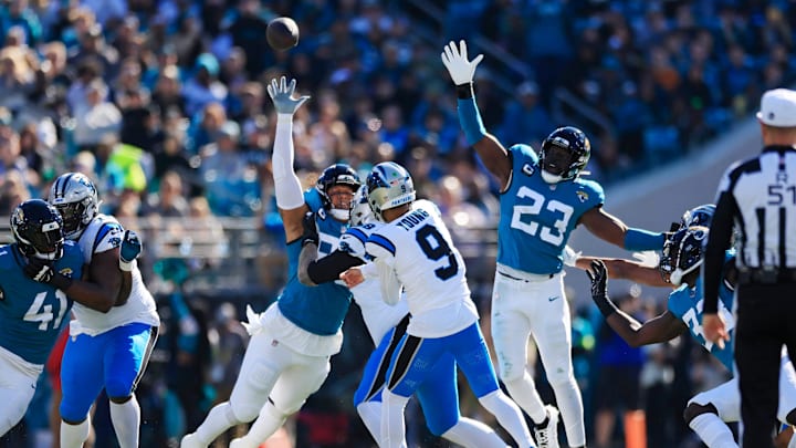 Carolina Panthers quarterback Bryce Young (9) touchback as Jacksonville Jaguars defensive end Roy Robertson-Harris (95) and linebacker Foyesade Oluokun (23) defend during the first quarter of a regular season NFL football matchup Sunday, Dec. 31, 2023 at EverBank Stadium in Jacksonville, Fla. The Jacksonville Jaguars blanked the Carolina Panthers 26-0. [Corey Perrine/Florida Times-Union]