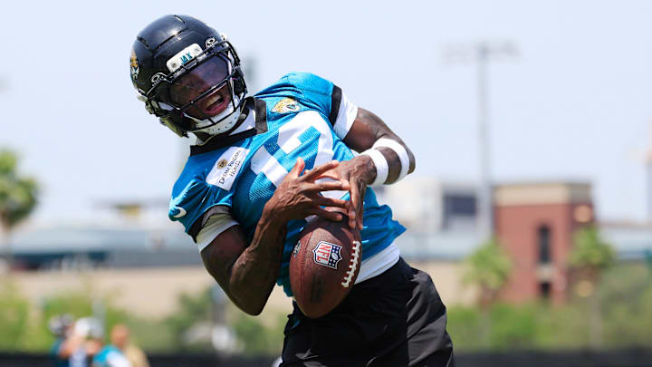 Jacksonville Jaguars wide receiver Travis Hunter (12) can't haul in a reception during the first organized team activity at Miller Electric Center Monday, May 19, 2025 in Jacksonville, Fla.