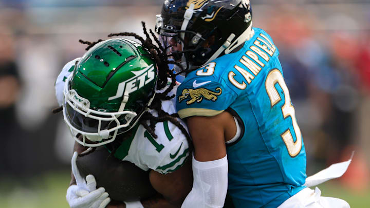 New York Jets wide receiver Davante Adams (17) is tackled by Jacksonville Jaguars cornerback Tyson Campbell (3) during the third quarter Sunday, Dec. 15, 2024 at EverBank Stadium in Jacksonville, Fla. The Jets held off the Jaguars 32-25. [Corey Perrine/Florida Times-Union]
