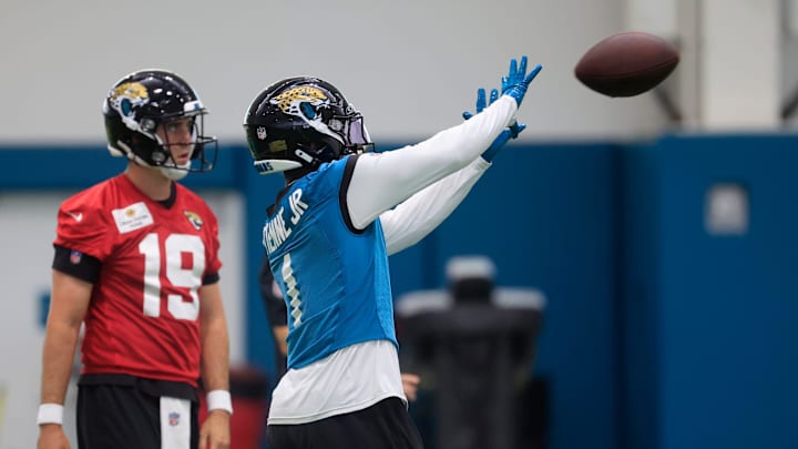 Jacksonville Jaguars running back Travis Etienne Jr. (1) catches a pass near quarterback Seth Henigan (19) during the 10th organized team activity at Miller Electric Center Wednesday, June 4, 2025 in Jacksonville, Fla. [Corey Perrine/Florida Times-Union]