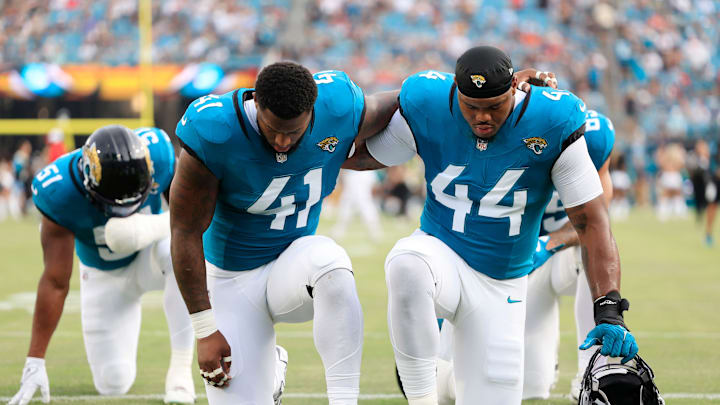 Jacksonville Jaguars defensive end Josh Hines-Allen (41) and defensive end Travon Walker (44) pray before a preseason NFL football game Saturday, Aug. 10, 2024 at EverBank Stadium in Jacksonville, Fla. The Jacksonville Jaguars defeated the Kansas City Chiefs 26-13. [Corey Perrine/Florida Times-Union]